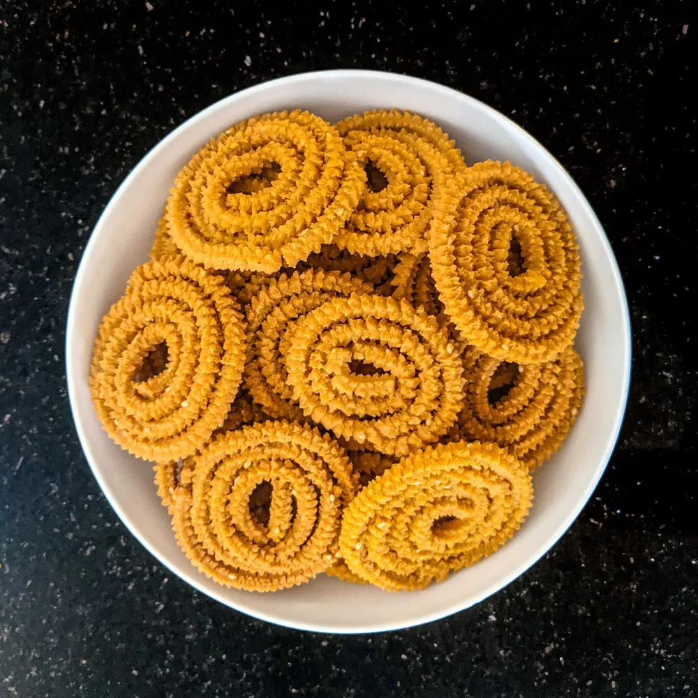 A bowl of golden chakli spirals
