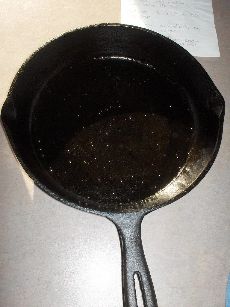 A dark, oiled cast iron skillet seen from above