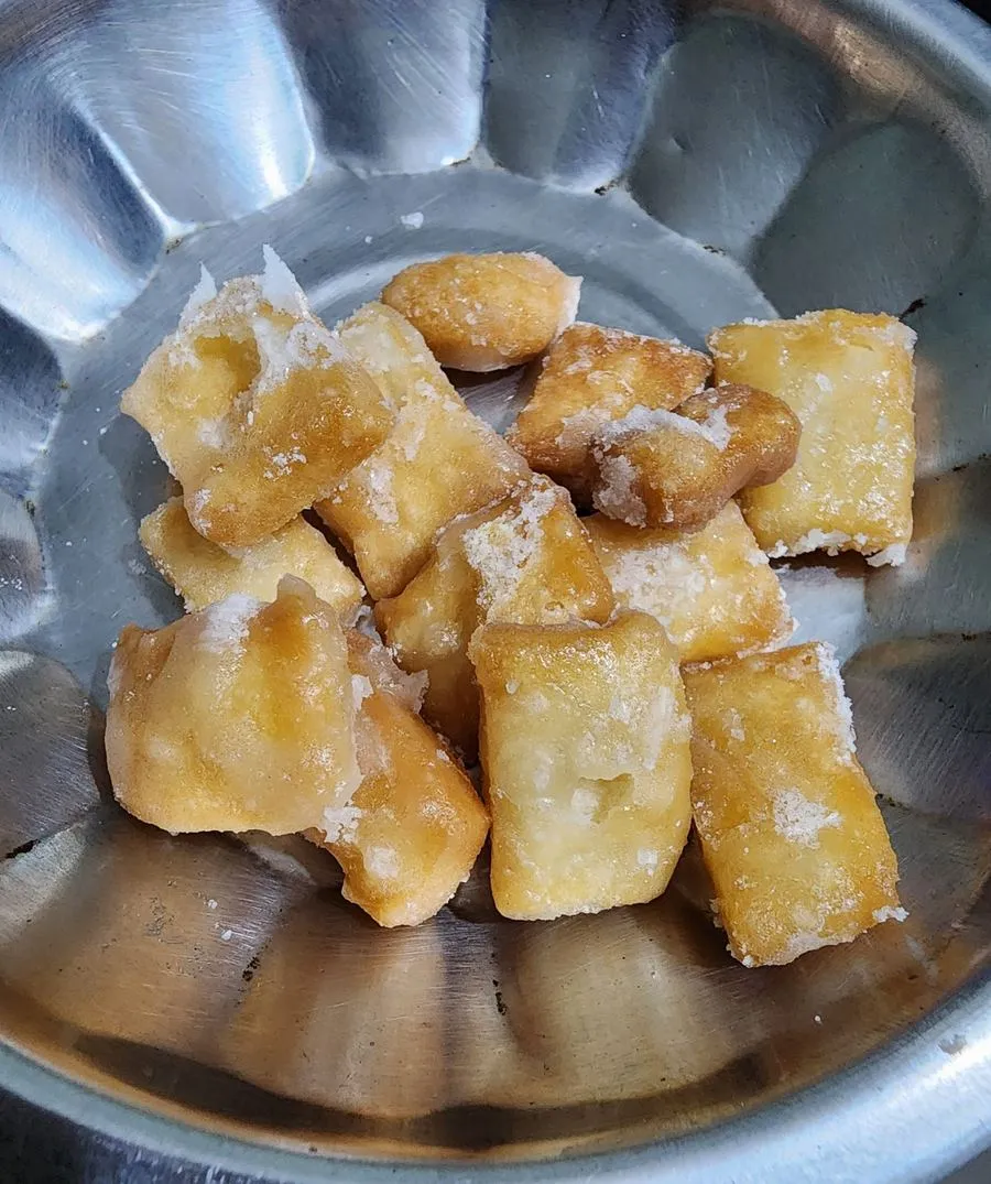 Sugar-coated shakarpara cubes in a bowl