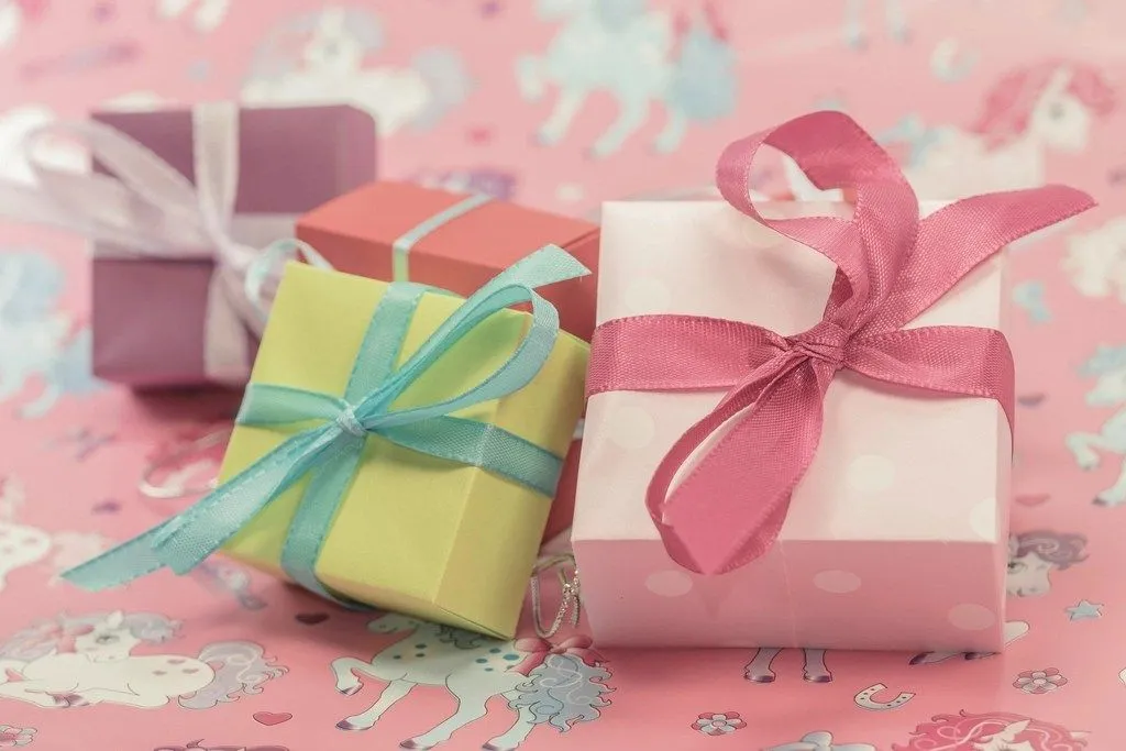 Three small wrapped gift boxes with ribbons