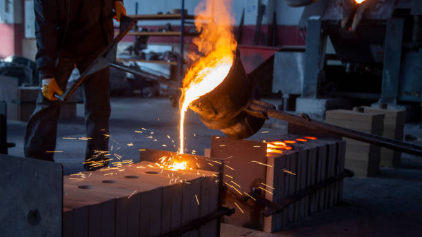 Molten iron being poured from a ladle into moulds at the foundry